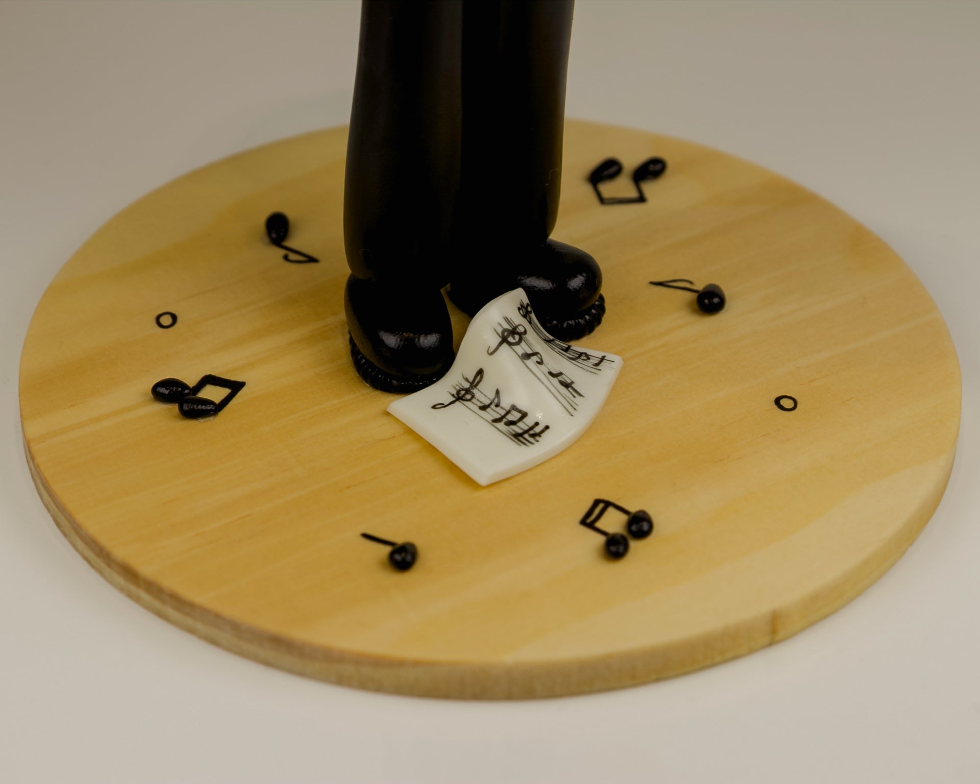 Shoes of a musician on a wooden stand with musical notes and a label